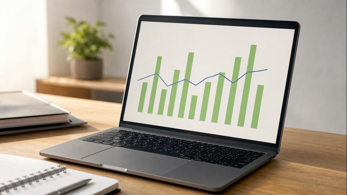 A laptop screen showing a clean, unbranded data visualization dashboard on a workspace desk